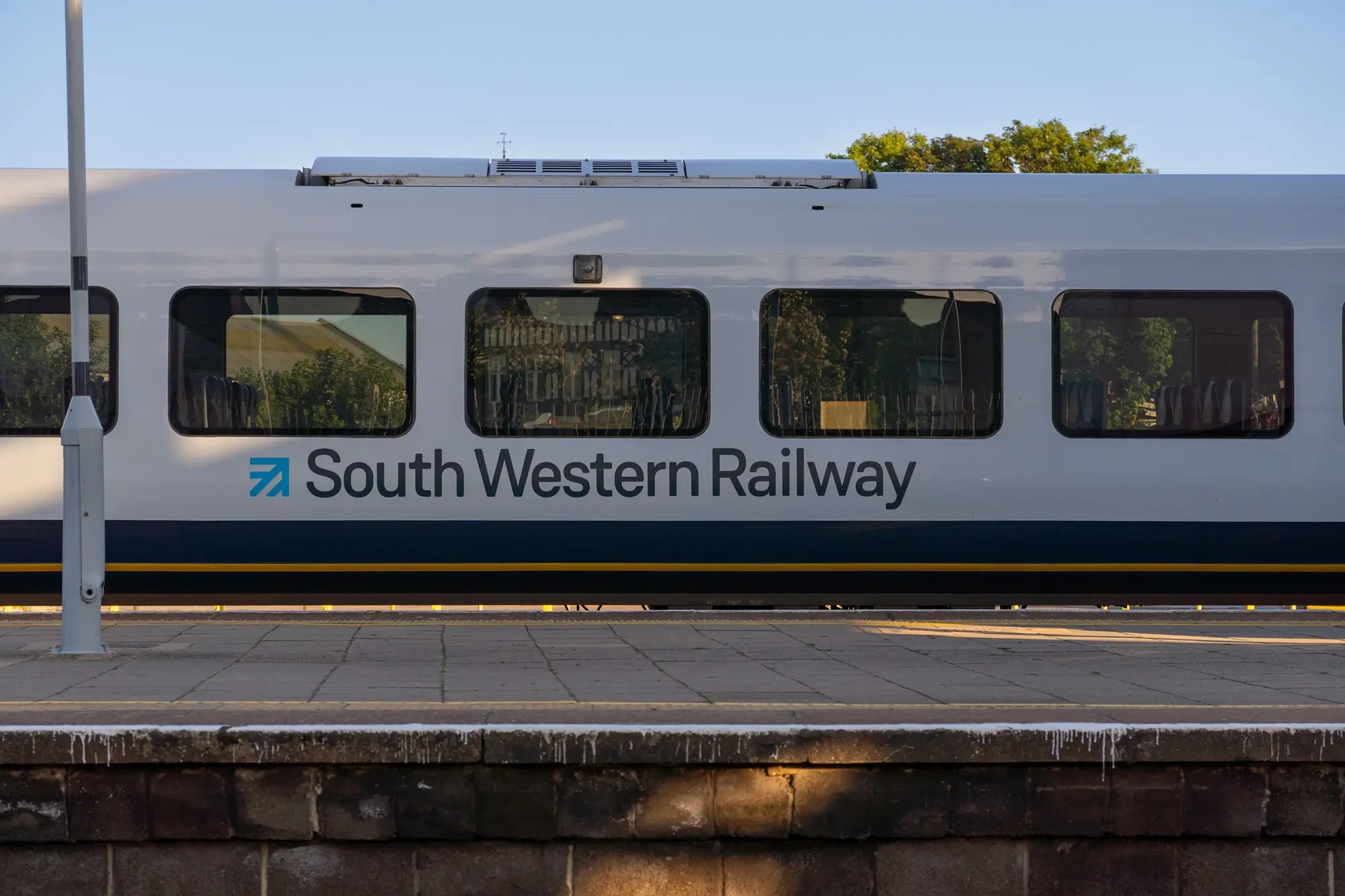 Bagshot Taxi South western railway train at a station platform