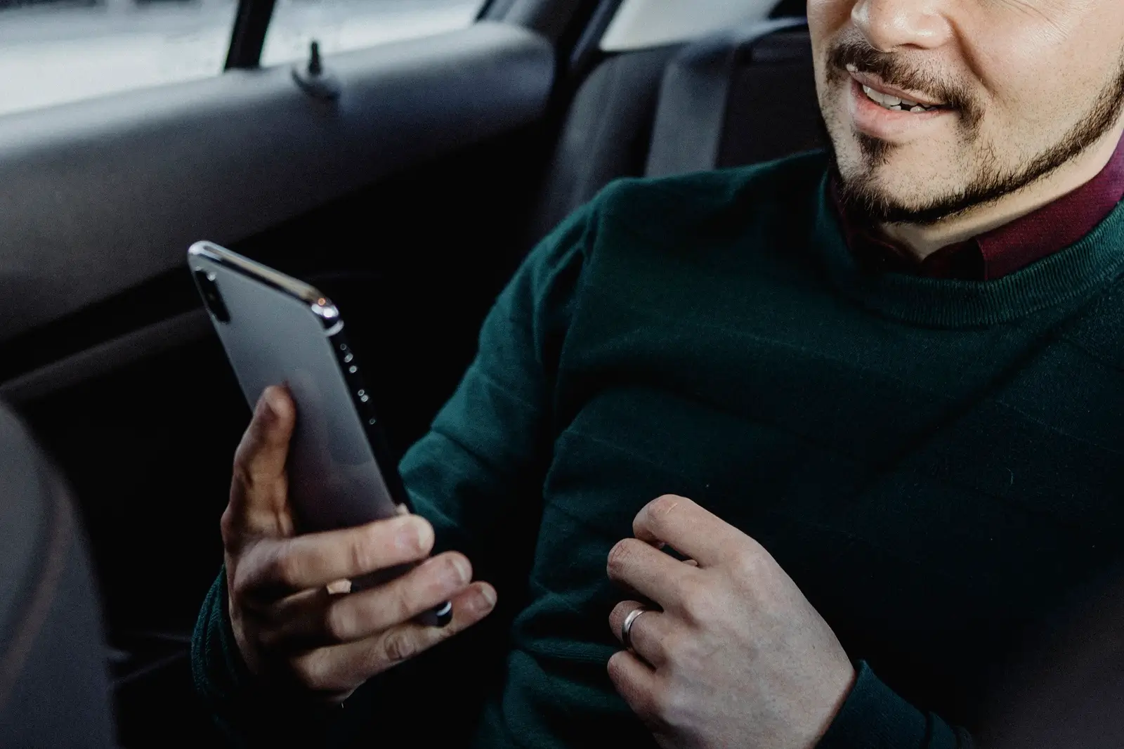 Farnborough Taxi Passenger looking at a map on a smartphone in a car