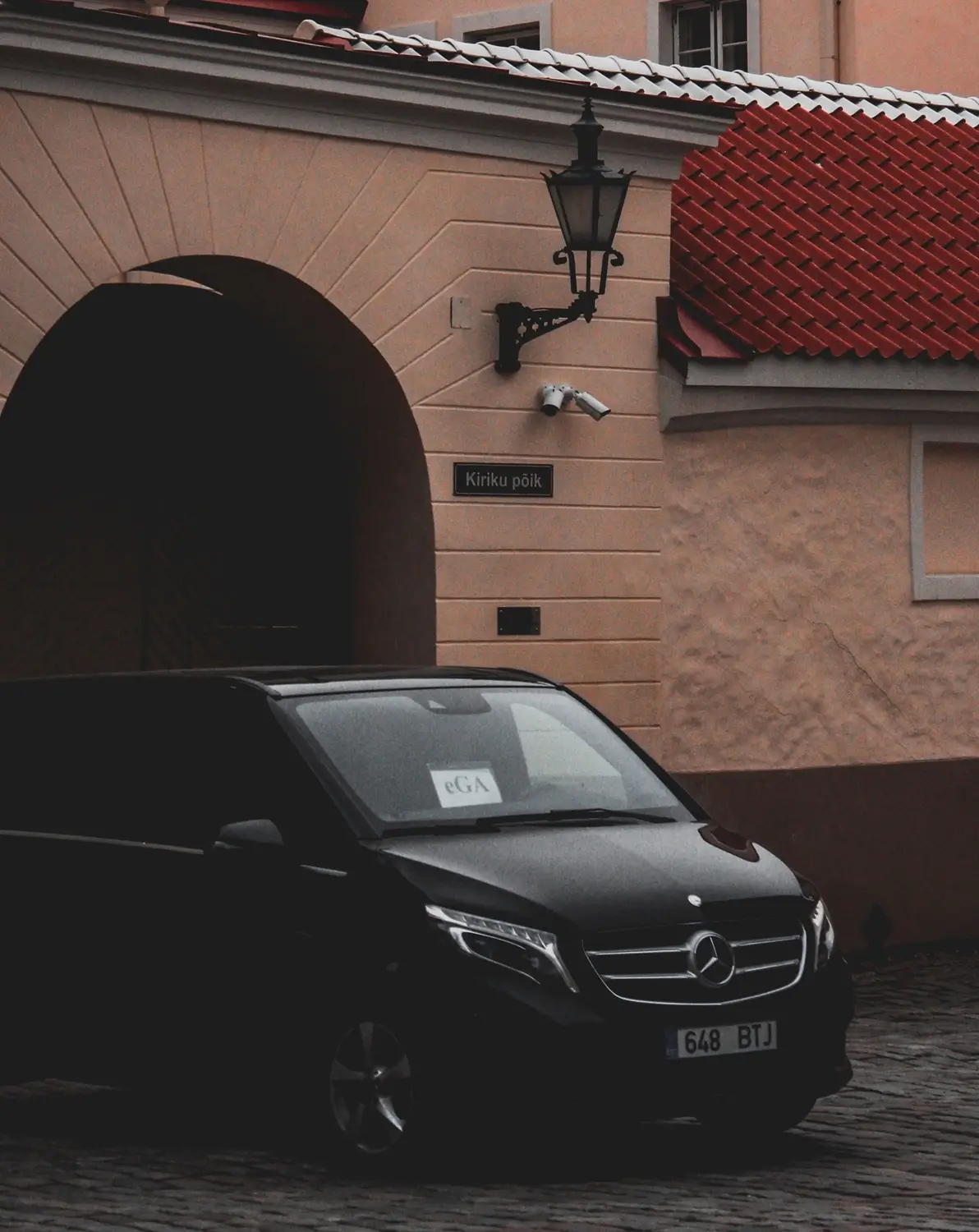 Sandhurst Taxi Black people carrier parked on a street, seen from behind